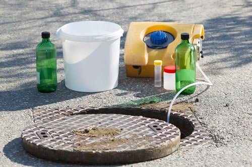 An automated sampler that is collecting a sample from a sewer line.