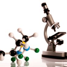 A microscope and a model of a molecule, showcasing the power of atomic force microscopy for surface imaging at atomic resolution.