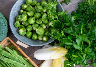 Image of Brussels sprouts and endives on a wooden background.