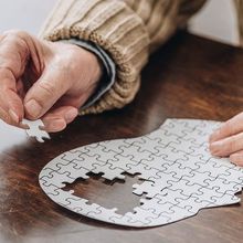 Cropped view of senior man playing with puzzles