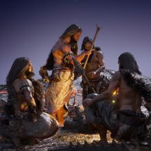 group of paleolithic people around a campfire