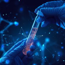 Conceptual image of hands wearing surgical gloves holding a test tube filled with a liquid biopsy sample.