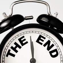 old-fashioned, black and white alarm clock with words "the end"