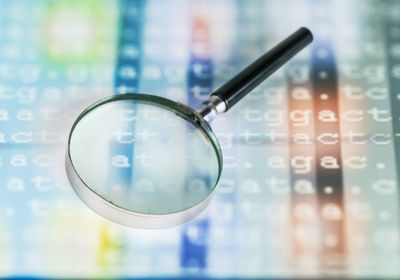 Magnifying glass over a DNA sequence