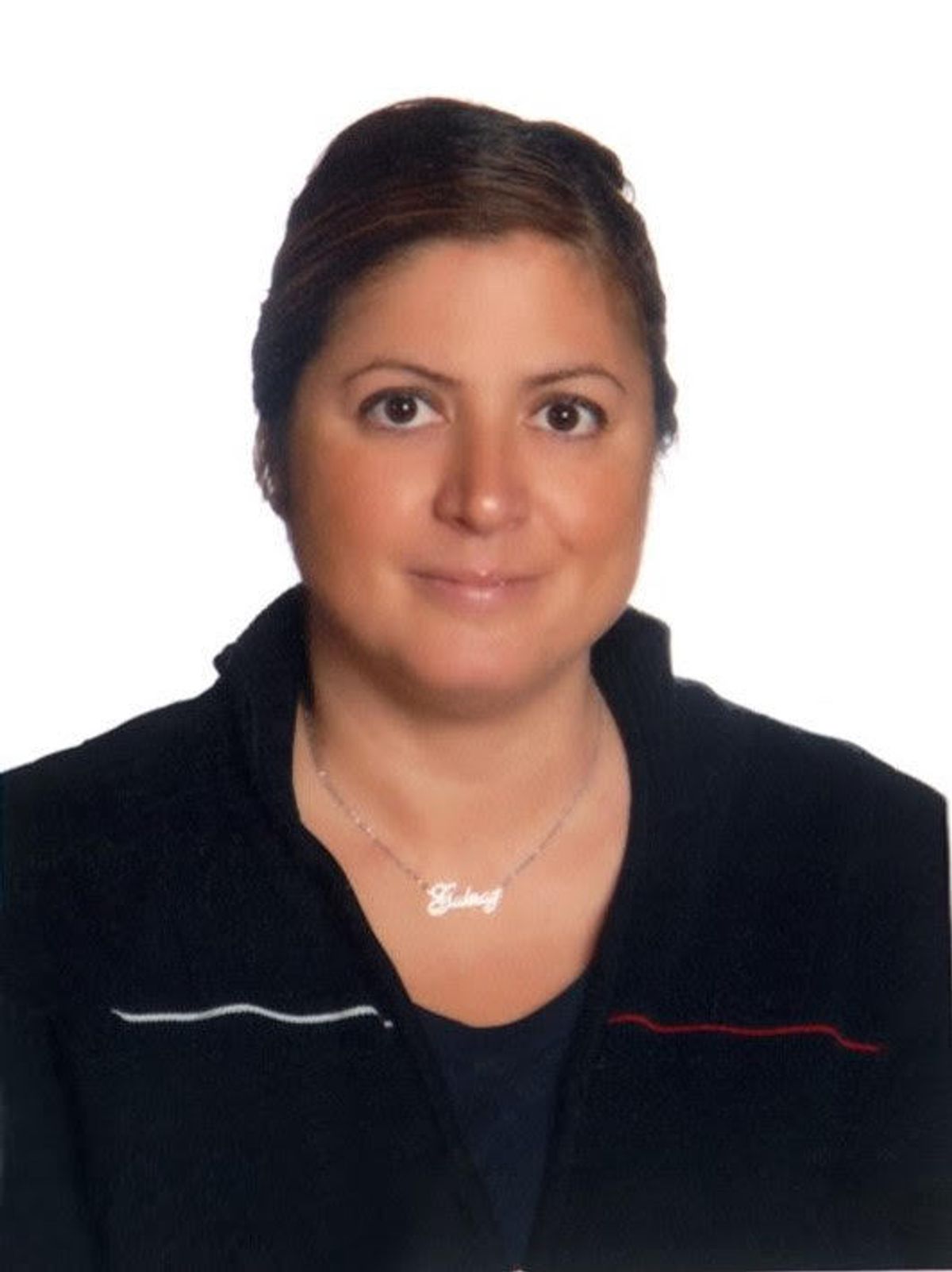 Portrait of scientist wearing a black shirt and facing the camera, with a white background.