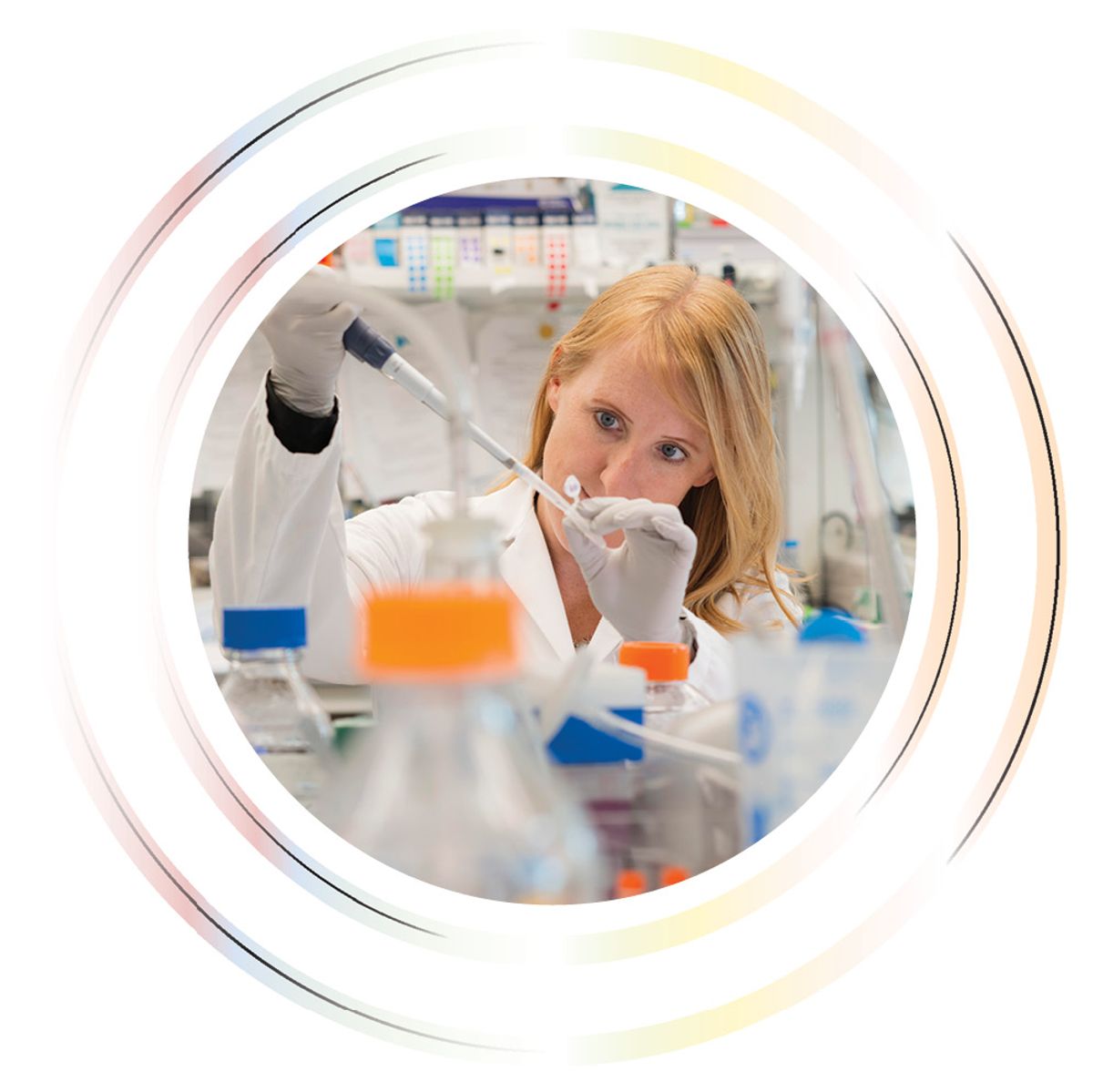 Image of a woman holding a pipette and a microcentrifuge tube in the laboratory.