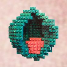 Image of an embryo built from Lego bricks showing cell populations in green and red.