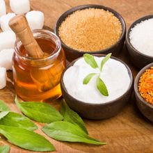 Variety of sweeteners - Stevia, sugar, pollen and honey stock photo