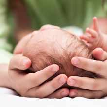 Cute sleeping newborn baby child on mother hands stock photo