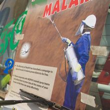 back of a pest control van with a picture of indoor residual sprayer for malaria