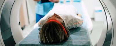 woman entering MRI machine on platform