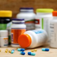 pill bottles and pills on a wooden table